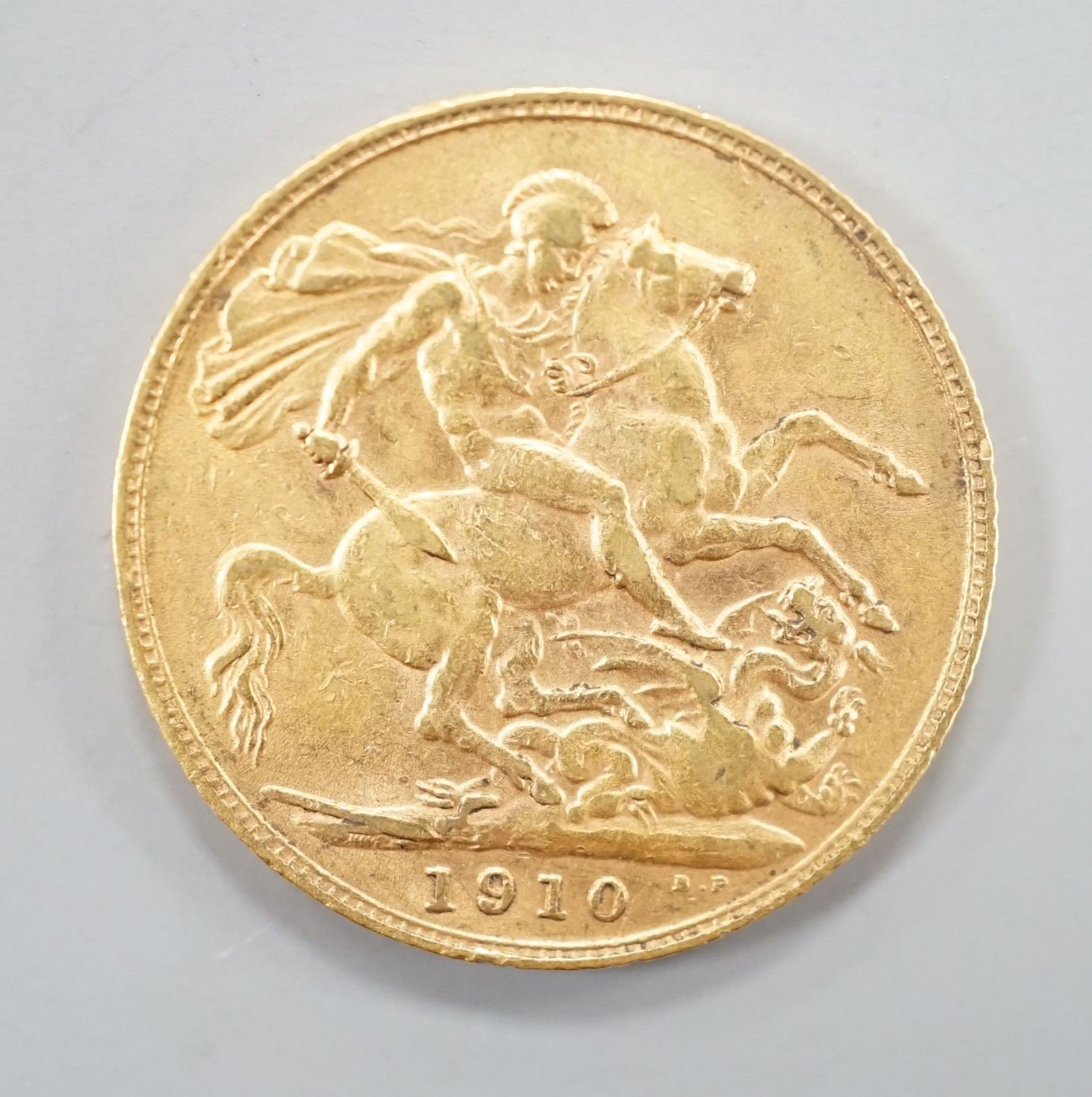 A George V 1910 gold sovereign.